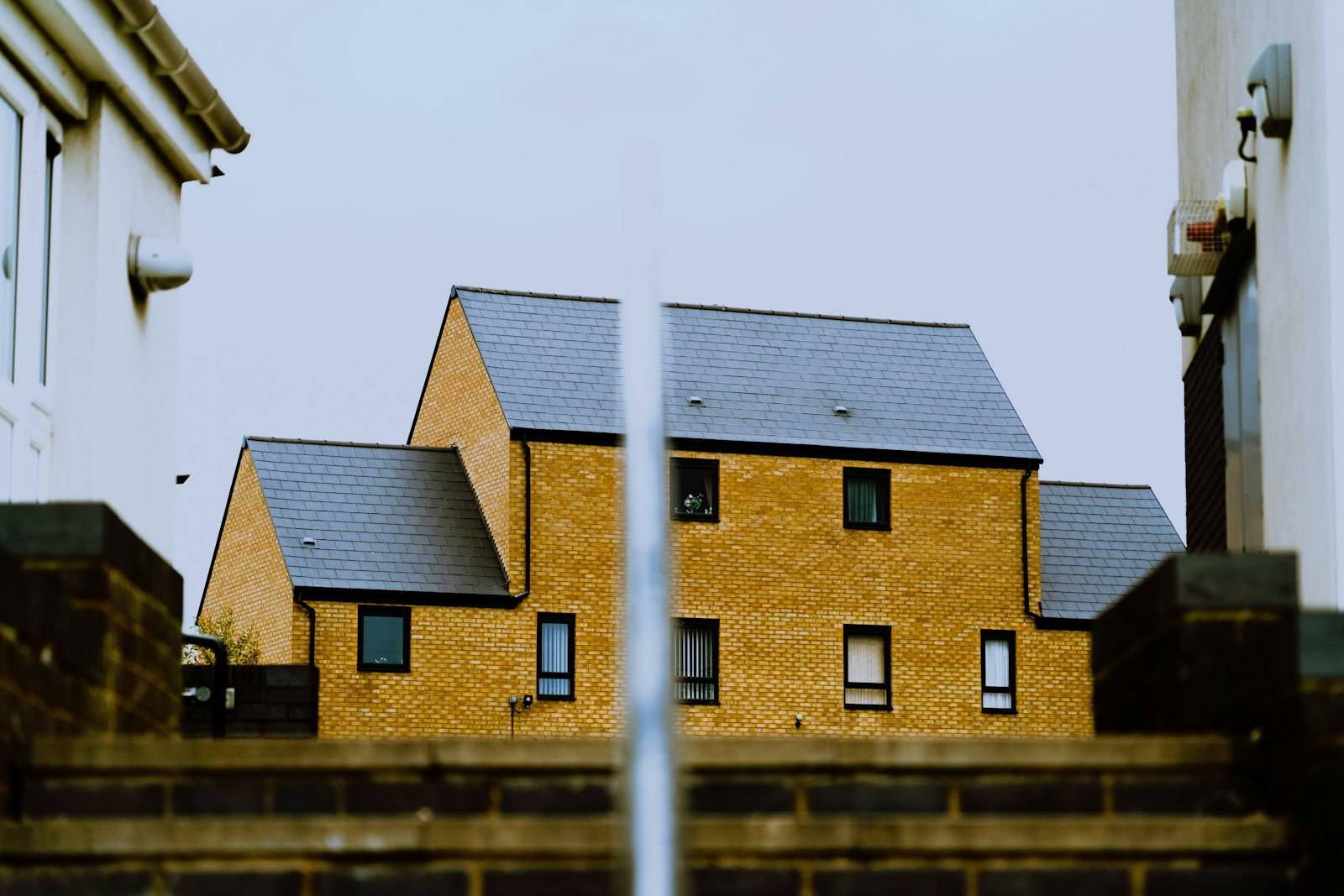 Modern yellow-brick new-build houses with slate roofs in Birmingham