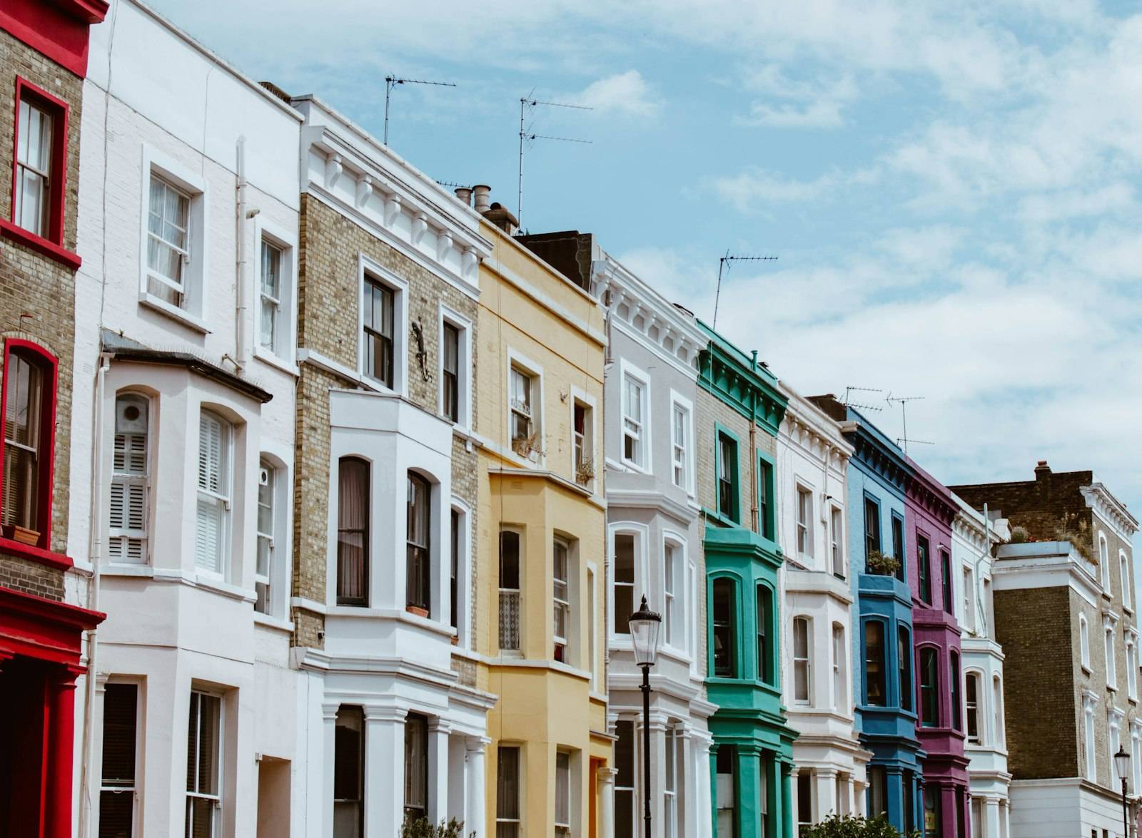 A row of brightly painted terraced houses in Notting Hill, London