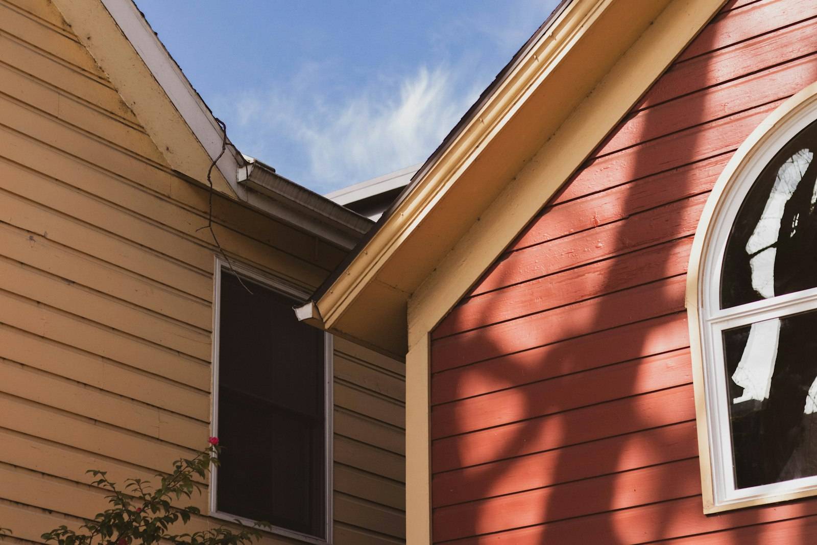 A close-up of a gutter running along a two-tone gabled roofline in Portland