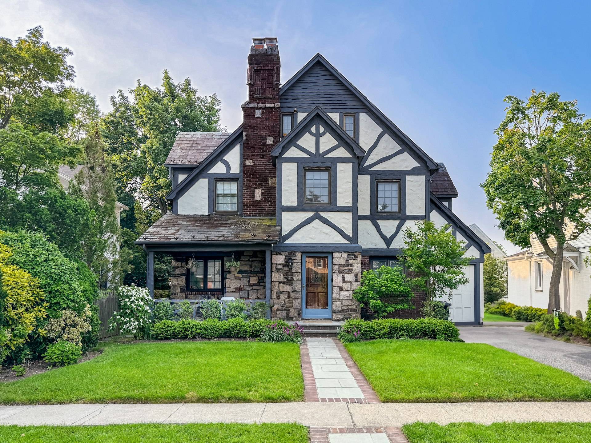 A brick and stucco Tudor Revival house with a prominent chimney